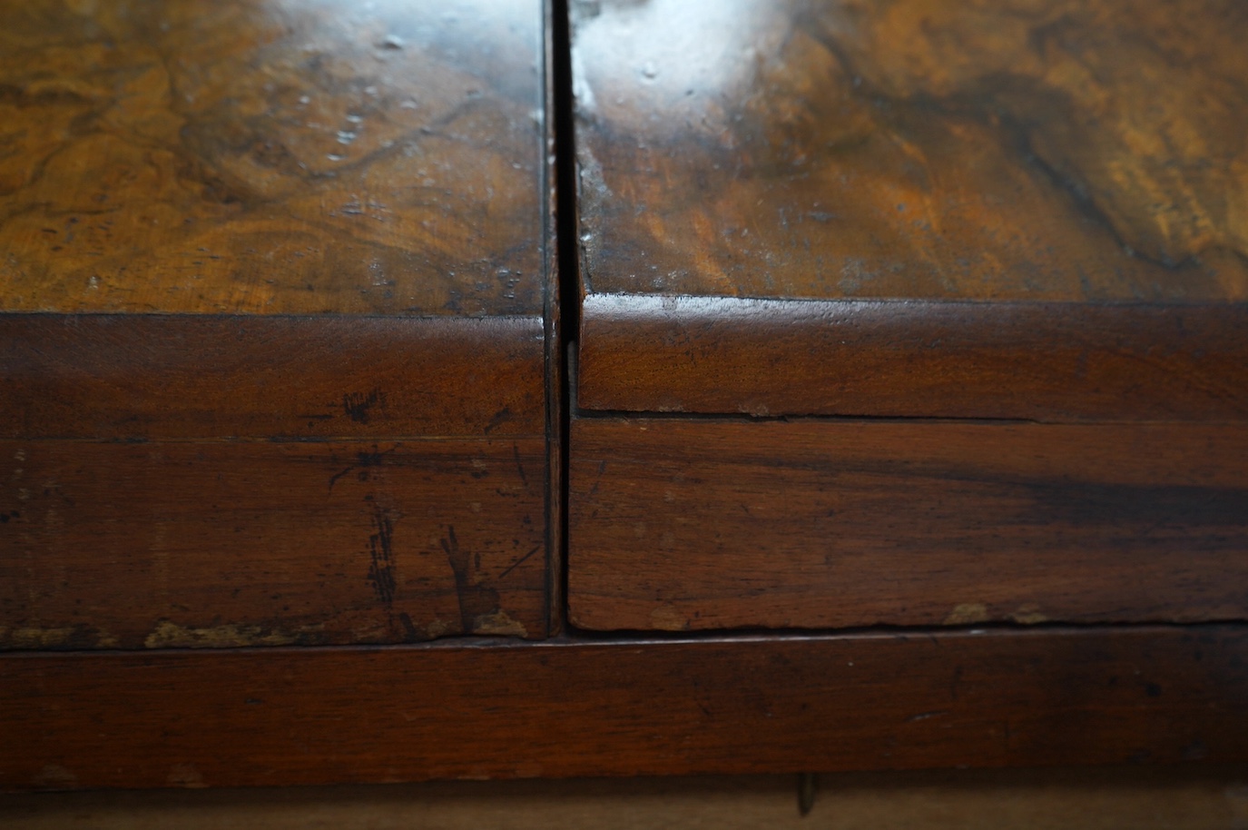 A Victorian burr walnut stationery rack, with two glass inkwells and partial label to the interior, with key, 37cm wide. Condition - fair